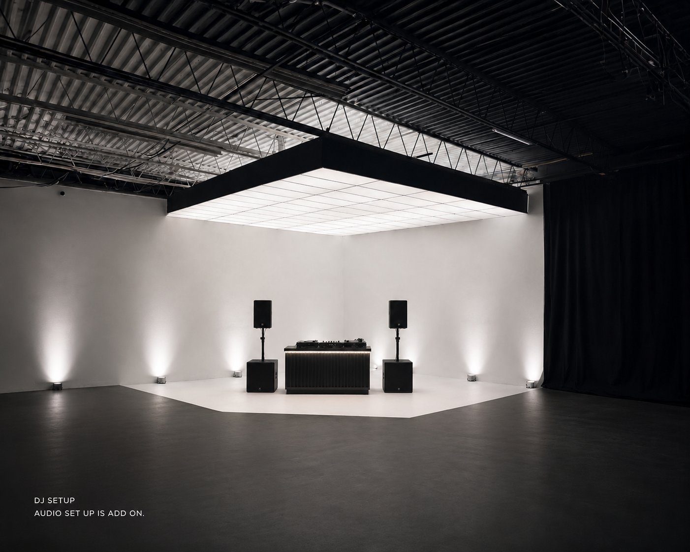 DJ booth set up in the white cyclorama