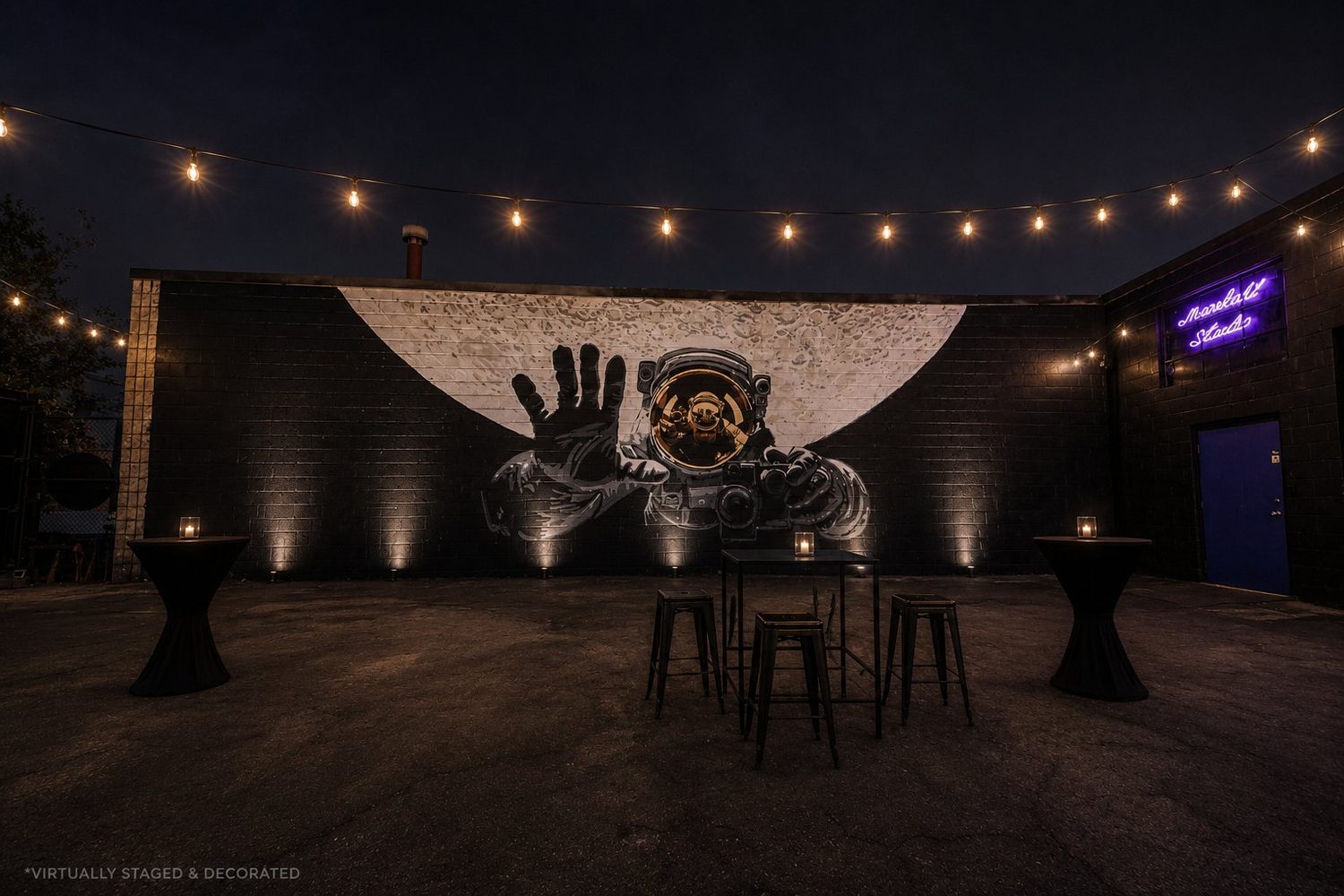 String-lit outdoor patio with the Moonlight astronaut mural